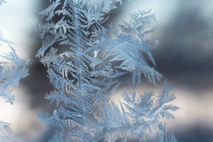 Ice Crystals In Window Glass, bokeh background Ice Crystals In Window Glass, bokeh background